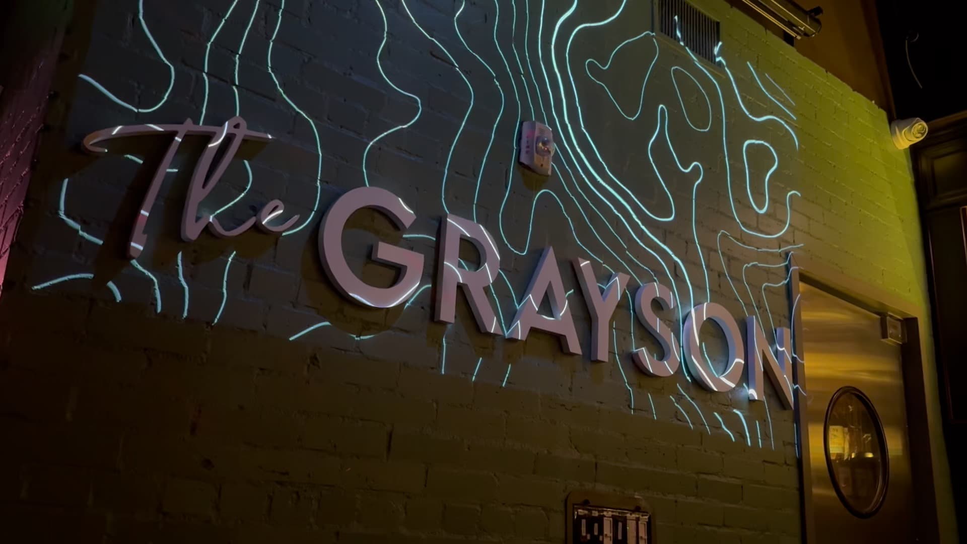 The Grayson DTLA site hero, low warm lighting over a dark interior